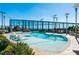 Modern swimming pool with lounge chairs in the water, a sundeck and lush landscaping for a serene escape at 3344 Peachtree Ne Rd # 3601, Atlanta, GA 30326