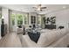 Comfortable living room featuring modern furniture, hardwood floors, large windows, and stylish decor at 409 Nix Ln, Lawrenceville, GA 30046