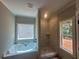 Bathroom features a soaking tub, tiled shower, and natural light at 879 Highway 101 N, Dallas, GA 30157