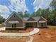 Charming new construction featuring stone accents, gray siding, and a welcoming walkway to the front door at 879 Highway 101 N, Dallas, GA 30157