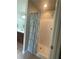 Bathroom with shower/tub, shower curtain, and cherry cabinets at 487 Cypher Dr, Suwanee, GA 30024