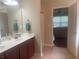 Bathroom with dual sinks, cherry cabinets, and shower stall at 487 Cypher Dr, Suwanee, GA 30024