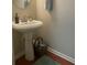 Bathroom with pedestal sink, modern faucet, and neutral paint at 487 Cypher Dr, Suwanee, GA 30024