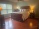 Serene bedroom with hardwood floors, a cozy bed, and ample natural light at 487 Cypher Dr, Suwanee, GA 30024