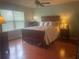 Bedroom with hardwood floors, large window, and comfortable bed at 487 Cypher Dr, Suwanee, GA 30024