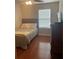 Cozy bedroom with hardwood floors, a comfortable bed, and a dresser at 487 Cypher Dr, Suwanee, GA 30024