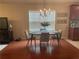 Bright dining room with hardwood floors and a modern chandelier at 487 Cypher Dr, Suwanee, GA 30024