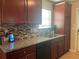 Well-appointed kitchen with granite countertops, stainless steel appliances, and a stylish mosaic tile backsplash at 487 Cypher Dr, Suwanee, GA 30024