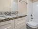 Bathroom featuring granite countertop and bathtub with white tile at 535 Transit Cir, Atlanta, GA 30349