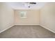 Bedroom featuring neutral carpet, a ceiling fan, and natural light from the window at 535 Transit Cir, Atlanta, GA 30349