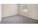 Bedroom featuring neutral carpet, a window, and white trim at 535 Transit Cir, Atlanta, GA 30349
