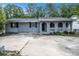 Ranch style home with gray brick porch and large driveway at 535 Transit Cir, Atlanta, GA 30349