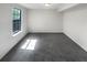 Finished basement area with natural light, neutral paint, and carpeted flooring at 1950 Matthew Way, Lithonia, GA 30058