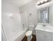 Clean bathroom featuring a tub-shower combo, vanity, and neutral tiling at 1950 Matthew Way, Lithonia, GA 30058
