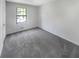 Bedroom features new carpet and a large window providing natural light at 1950 Matthew Way, Lithonia, GA 30058