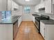 Functional kitchen with white cabinets, stainless steel appliances, and tile flooring at 1950 Matthew Way, Lithonia, GA 30058