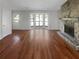Bright living room with a stone fireplace, large bay window, and hardwood floors at 1950 Matthew Way, Lithonia, GA 30058