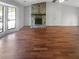 Open living room features hardwood floors, a stone fireplace and large windows at 1950 Matthew Way, Lithonia, GA 30058