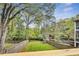 Fenced backyard with well-maintained lawn, mature trees, and playset, visible from a wooden deck at 2244 Spink Nw St, Atlanta, GA 30318
