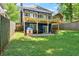 Grassy backyard featuring a patio, a deck, playset, and privacy fence offers ample space for recreation at 2244 Spink Nw St, Atlanta, GA 30318