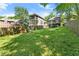 Large backyard featuring green grass, wooden fence, play set, and exterior house view at 2244 Spink Nw St, Atlanta, GA 30318