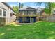 Spacious backyard featuring a well-manicured lawn, patio, and second story deck at 2244 Spink Nw St, Atlanta, GA 30318