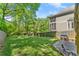 Backyard featuring a large lawn, mature trees, a playset, and patio area, perfect for Gathering fun at 2244 Spink Nw St, Atlanta, GA 30318