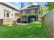 Well-maintained backyard with a large lawn, patio, and fenced perimeter at 2244 Spink Nw St, Atlanta, GA 30318