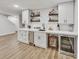 Basement wet bar featuring white cabinetry, beverage fridge, and ample counter space at 2244 Spink Nw St, Atlanta, GA 30318
