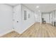 Finished basement with modern wood flooring and a convenient utility door for easy access at 2244 Spink Nw St, Atlanta, GA 30318