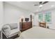 Serene bedroom featuring a plush bed, TV, and desk with natural light from a window at 2244 Spink Nw St, Atlanta, GA 30318