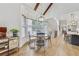 Open-concept dining area featuring a chandelier, bay window, and hardwood floors at 2244 Spink Nw St, Atlanta, GA 30318