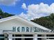Henri's Bakery exterior shows a retro building with a bright sign on a sunny day at 2244 Spink Nw St, Atlanta, GA 30318