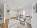 Hallway with seating area, hardwood flooring, crown molding, and neutral paint at 2244 Spink Nw St, Atlanta, GA 30318