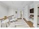 Bright hallway with seating area, hardwood flooring, crown molding, and neutral paint at 2244 Spink Nw St, Atlanta, GA 30318