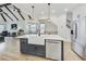 Open-concept kitchen with a large center island, stainless steel appliances, hardwood floors, and an adjacent living area at 2244 Spink Nw St, Atlanta, GA 30318
