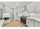 Bright, modern kitchen featuring white cabinetry, stainless steel appliances, a patterned floor, and hardwood floors at 2244 Spink Nw St, Atlanta, GA 30318