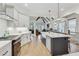Spacious kitchen with a large island, stainless steel appliances, hardwood floors, and an open layout to the living room at 2244 Spink Nw St, Atlanta, GA 30318