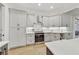 Modern kitchen with sleek white cabinets, stainless steel appliances, and hardwood floors at 2244 Spink Nw St, Atlanta, GA 30318