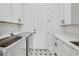 Well-equipped laundry room with modern appliances, storage cabinets, and designer tile floor at 2244 Spink Nw St, Atlanta, GA 30318