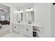 Bright main bathroom featuring dual vanities, updated fixtures, and mirrors at 2244 Spink Nw St, Atlanta, GA 30318