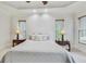 Cozy main bedroom with a tray ceiling, ceiling fan, and neutral decor at 2244 Spink Nw St, Atlanta, GA 30318