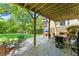 Cozy outdoor patio with dining set and view of the expansive, grassy backyard at 2244 Spink Nw St, Atlanta, GA 30318