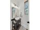 Stylish powder room with a vessel sink, black fixtures, and decorative mirror at 2244 Spink Nw St, Atlanta, GA 30318