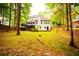 Lush backyard with a deck, stone patio, and mature trees at 6147 Pritchett Dr, Powder Springs, GA 30127