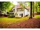 Back exterior of home featuring a deck and a small backyard patio at 6147 Pritchett Dr, Powder Springs, GA 30127