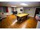 Finished basement with pool table, bar stool seating, hardwood floors and tv area at 6147 Pritchett Dr, Powder Springs, GA 30127