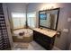 Bright bathroom featuring soaking tub, vanity with granite countertop, and tile flooring at 6147 Pritchett Dr, Powder Springs, GA 30127