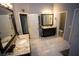 Spacious bathroom with granite countertops, dark cabinetry, and tile flooring at 6147 Pritchett Dr, Powder Springs, GA 30127