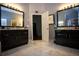 Beautiful bathroom with double vanities, granite countertops, and large mirrors at 6147 Pritchett Dr, Powder Springs, GA 30127